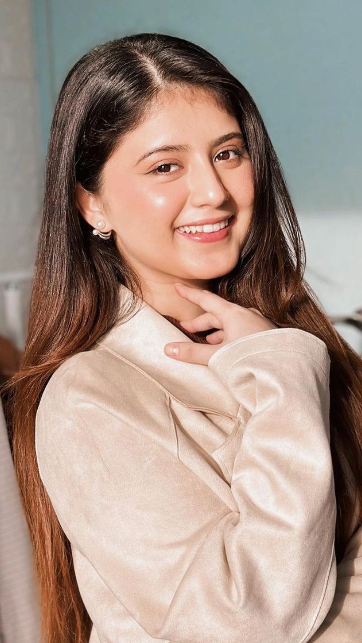 Arishfa smiling in a soft cream outfit