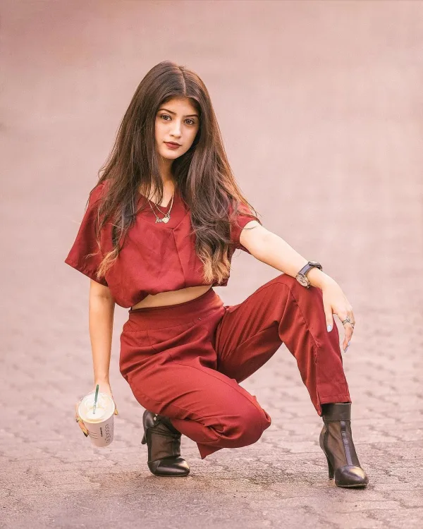 Arishfa Khan — Arishfa Khan — bold in burgundy.